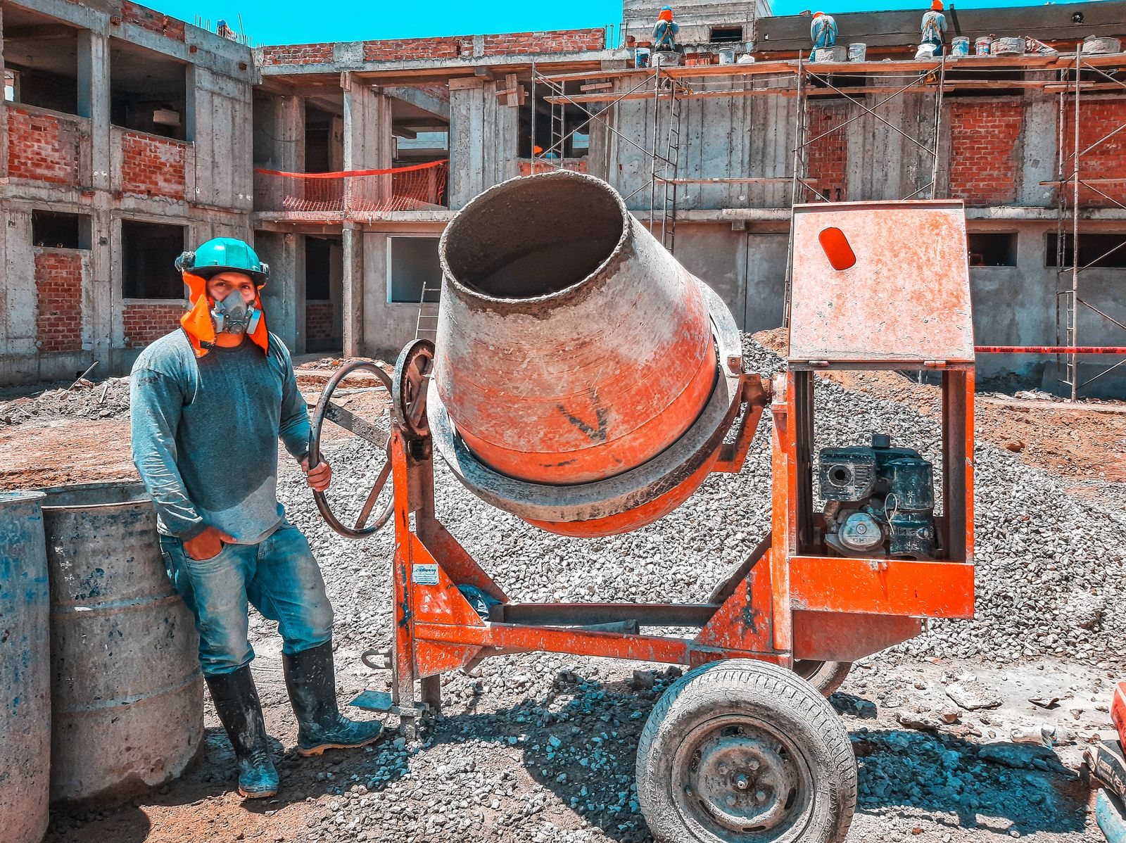 La excavación del terreno con la mezcladora y los operarios trabajando.
